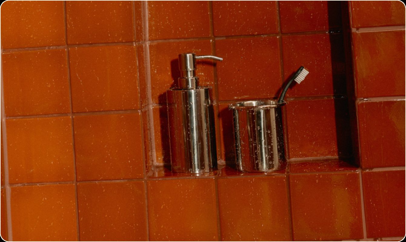 Caesar Laurel Density Tonic in a tiled shower niche